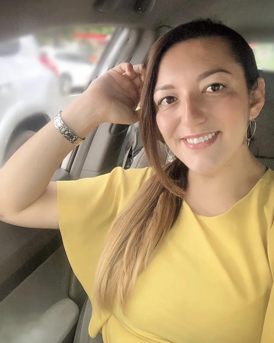 Jess smiling in a yellow top